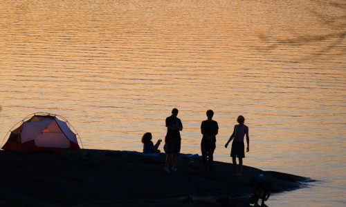 silhouette tent water swim sunset french river